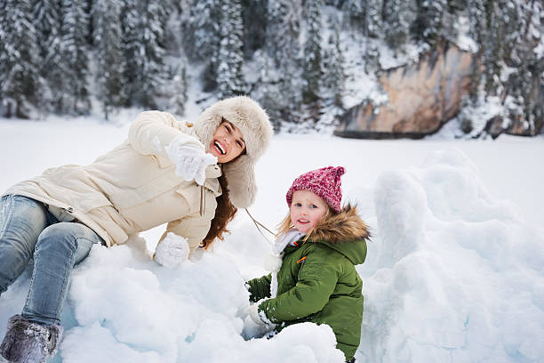 istock Happy mother pointing in camera to child while playing outdoors 507207756