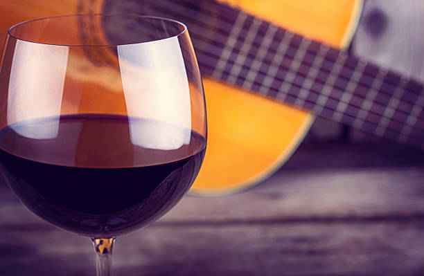 guitar and Wine on a wooden table stock photo