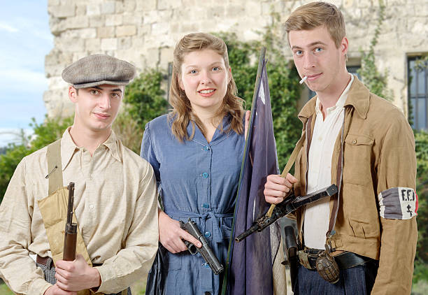 three young French Resistance, vintage clothes and weapons, reen