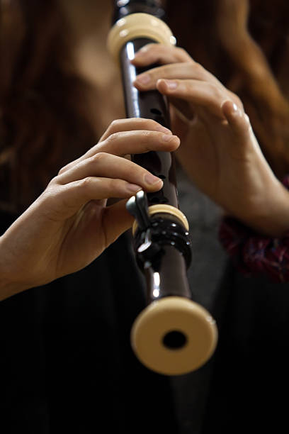 Block flute in the hands of the musician closeup