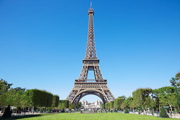 Eiffel tower and green Field of Mars in Paris Eiffel tower, sunny summer day with blue sky and green Field of Mars in Paris eiffel tower stock pictures, royalty-free photos & images