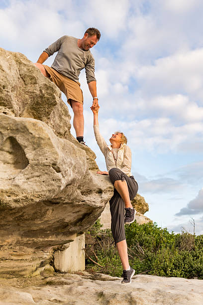 istock Active Fit Mature Couple Helping Each Other Hiking 507210156