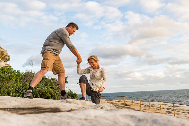 Active Fit Mature Couple Helping Each Other Hiking