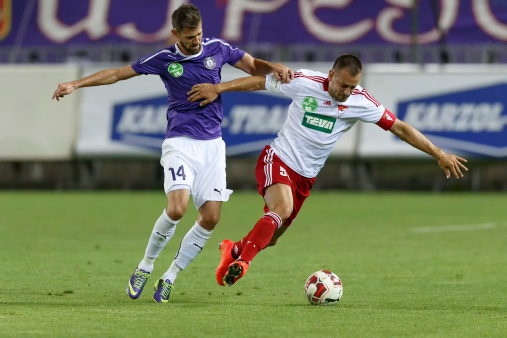 Budapest, Hungary - August 16, 2014: Duel between Gabor Nagy of UTE (l) and Peter Szakaly of DVSC during UTE vs. DVSC OTP Bank League football match at Szusza Stadium on August 16, 2014 in Budapest, Hungary.