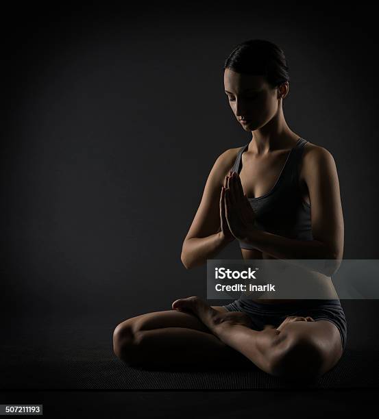 Yoga Woman Meditate Sitting In Lotus Pose Exercise Stock Photo - Download Image Now - Adult, Adults Only, Back Lit