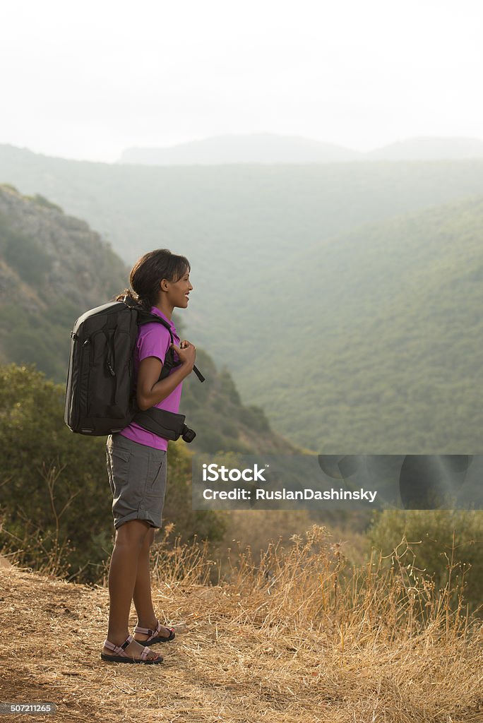 Outdoor vacation. Young woman backpacker tourist traveling outdoor in Mediterranean forest. Sandal Stock Photo