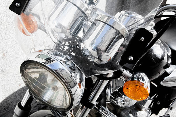 Close-up of a motorbike parked on a pavement