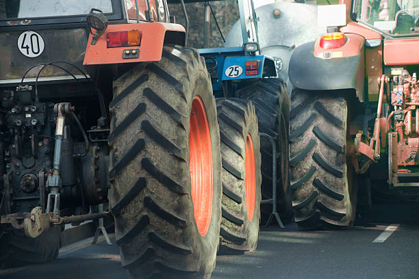 istock Rear view of multicolored tractors, wheels and engines. 507212566