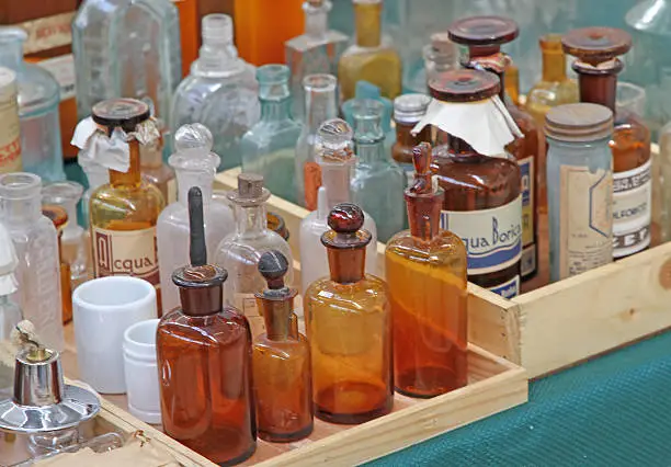 very old bottle of glass with medicine for sale in a european flea market