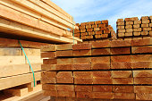 Image of wood planks / sawmill posts in timber yard piles