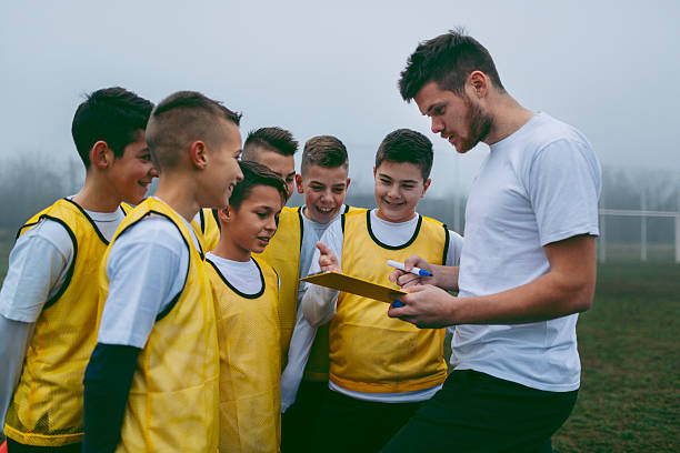 istock Coach Giving Instruction To His Kids Soccer Team 507212986