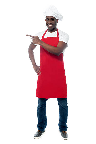 Handsome male chef showing menu stock photo