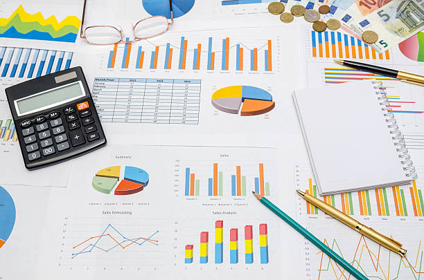 istock finance report with glasses, calculator and pen 507213282