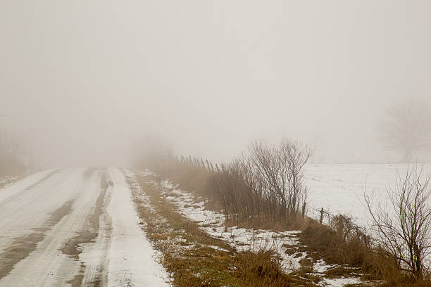 istock Snow Covered Rural Dirt Road And Farm Field 507213982