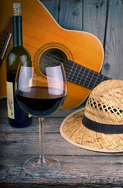 guitar and Wine on a wooden table stock photo