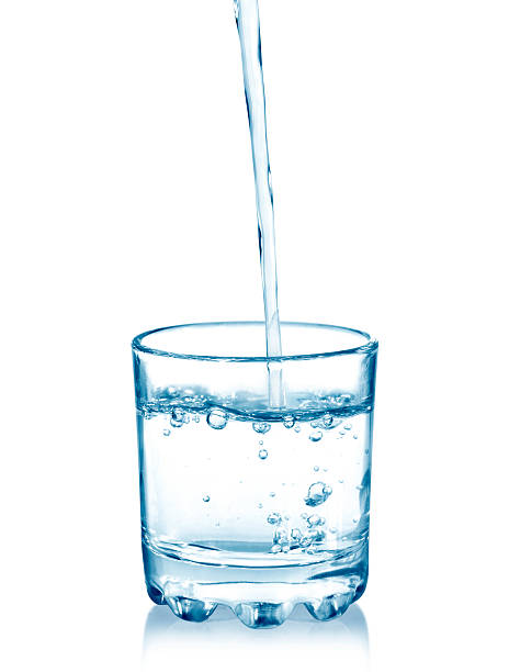 istock pouring water on a glass on white 507214536