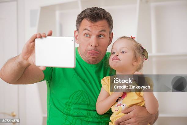 Father And Child Using Electronic Tablet At Home Stock Photo - Download Image Now - Adult, Camera - Photographic Equipment, Carefree