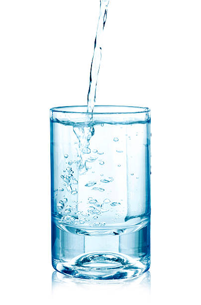 istock pouring water on a glass on white 507215010