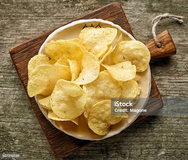 Potato Chips On Wooden Table Stock Photo - Download Image Now - Potato Chip, Bowl, Directly Above