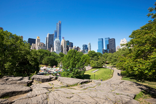 New York, USA - May 24, 2015: Victorian Gardens with the skyscrapers of Central Park South in New York. Victorian Gardens is a seasonal amusement park, which is located in Central Park.