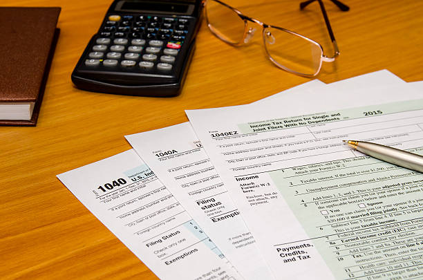 istock tax form 1040 for 2016 year with calculator 507215534
