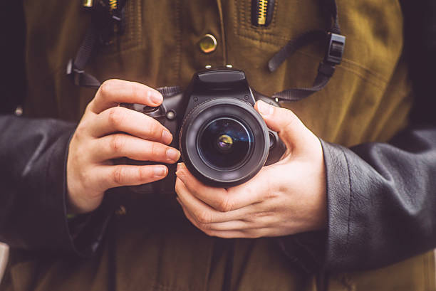 istock Young woman holding camera 507217790