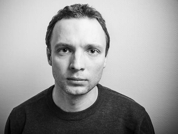 istock Young serious man studio portrait, black and white 507218094
