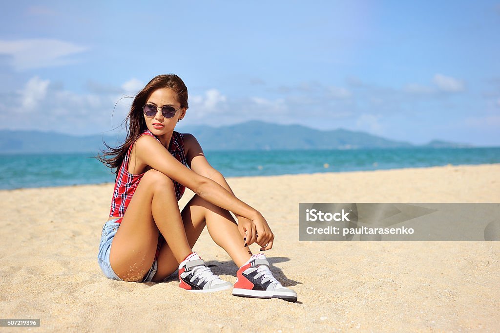 Portrait of stylish woman on a beach Adult Stock Photo