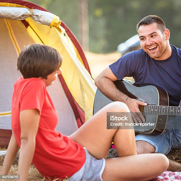 Couple Flirting At Camping Togetherness On Summer Stock Photo - Download Image Now - 20-29 Years, Adult, Camping