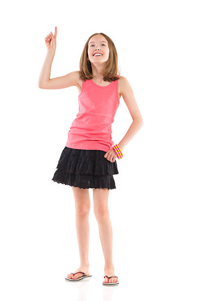 istock Smiling little girl pointing and looking up 507236859
