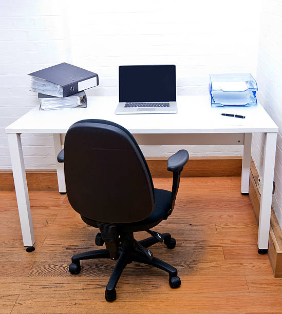 istock Empty office chair with laptop on desk 507237507
