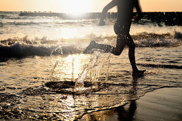 By the sea - running on the beach at sunset