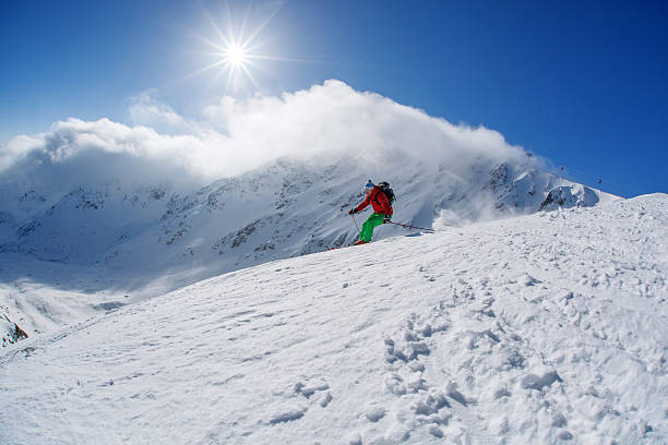 istock Skier skiing downhill in high mountains against sunset 507237861