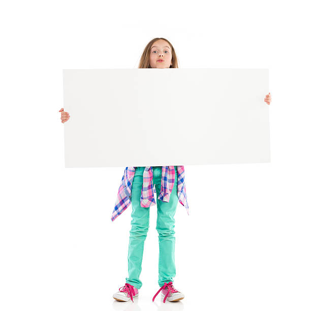 маленькая девочка с большой белый баннер - little girls pre adolescent child standing isolated стоковые фото и изображения