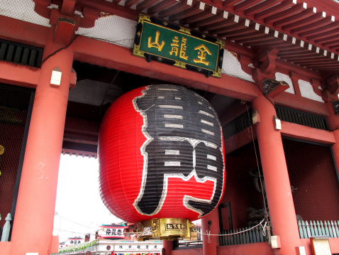 Tokyo, Japan - August 22, 2013: Red giant lantern hang on the large entrance gates (Kaminarimon) leading to Sensoji Temple.It is the symbol of Asakusa district.