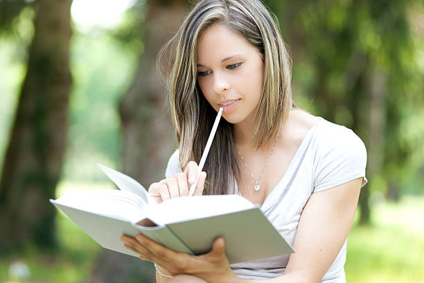 istock Woman reading a book at the park 507240569