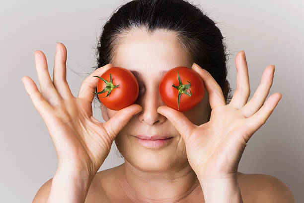 istock Asian woman showing tomatoes 507242711
