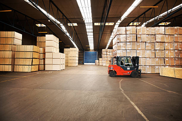 Your goods will be in a safe place A large warehouse storing big boxes with a forklift. unloading photos stock pictures, royalty-free photos & images
