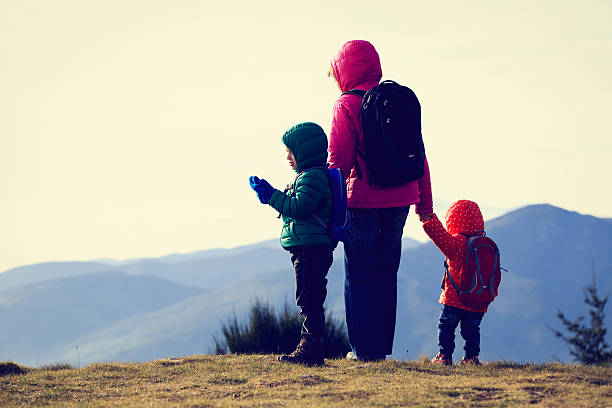 istock mother with two kids hiking in mountains 507246766