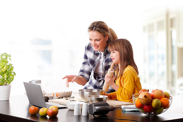 istock Mother and daugther baking together 507248072