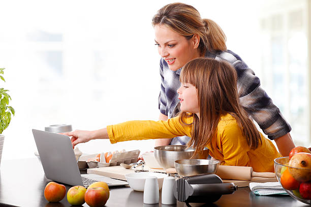 istock Mother and daugther baking together 507248220