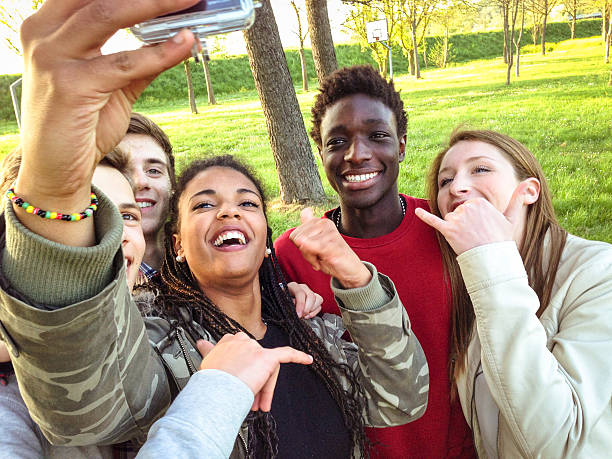 istock Group of college student laughing and doing a selfie 507249398