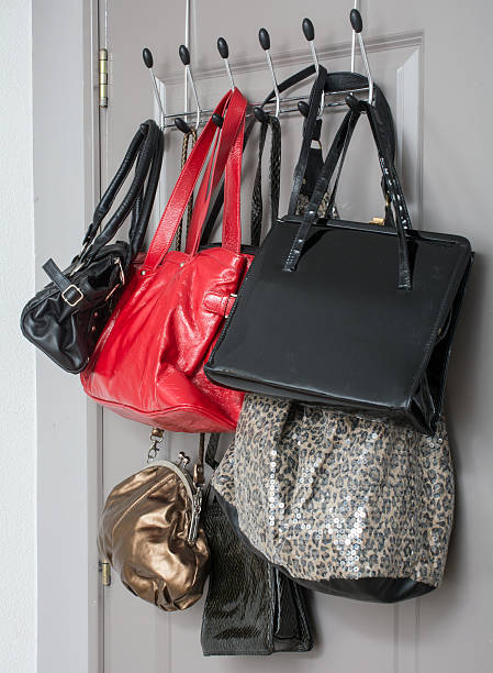 istock handbags on a clothes rack inside door 507250798
