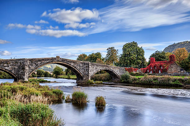 Pont Fawr Pont Fawr, famous medieval stone bridge across the river Conwy, and court house covered in red ivy  Llanrwst, Caernarfon, North Wales gwynedd photos stock pictures, royalty-free photos & images