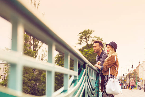 istock Happy tourists standing on the bridge, looking away 507252660