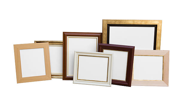 istock Classic wooden picture frames with blank canvas isolated on white 507252828