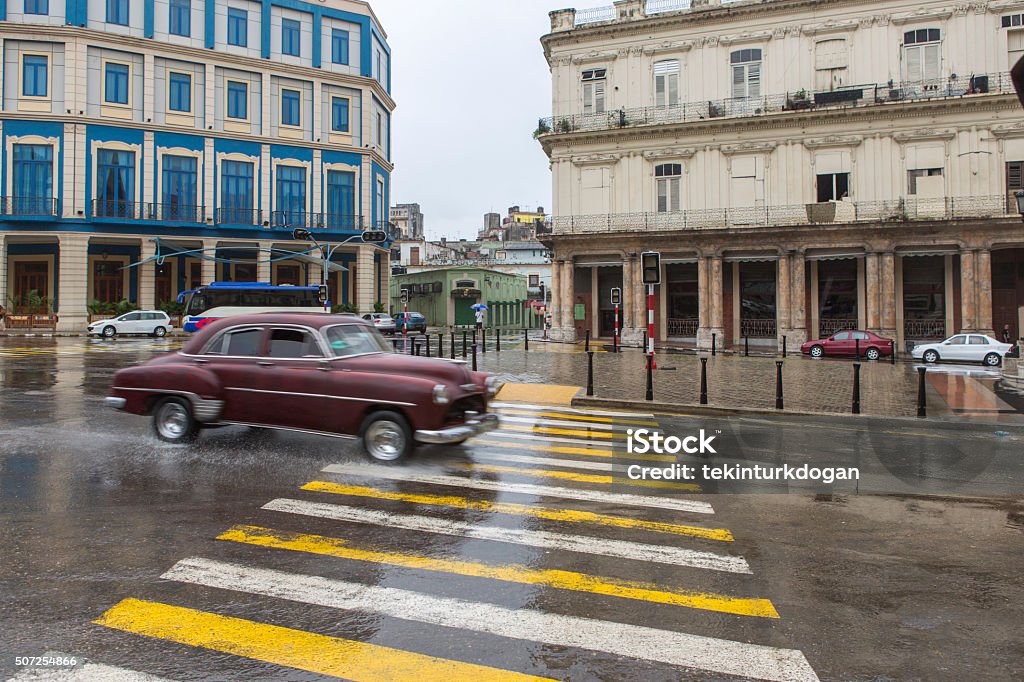 old historical american car at street of havana cuba driving old historical american car during the rain at street of havana cuba Antique Stock Photo