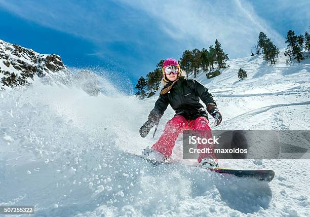 Woman Snowboarder In Motion In Mountains Stock Photo - Download Image Now - Snowboarding, Women, Snowboard