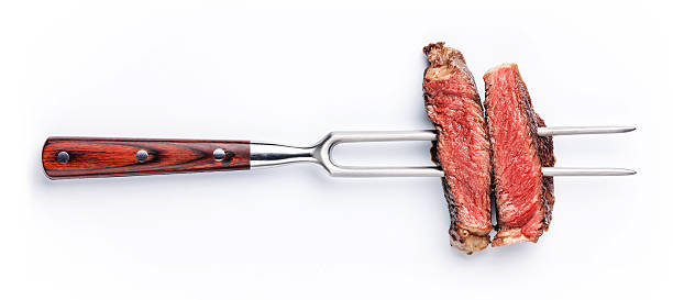 Slices of steak on meat fork stock photo