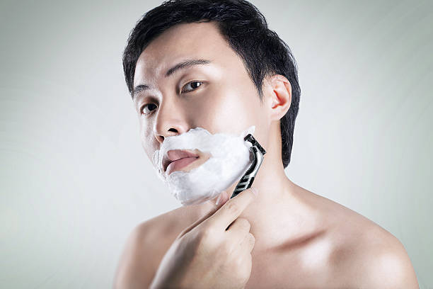 Asian man is shaving stock photo